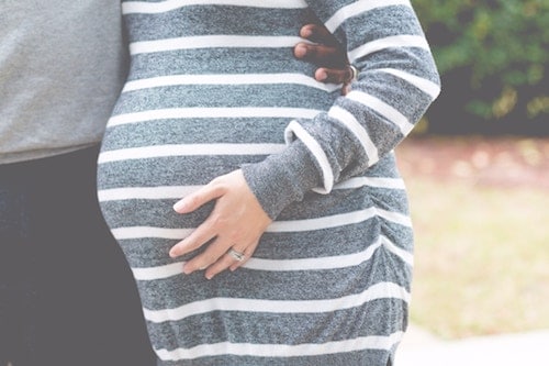 Women touching her pregnant stomach